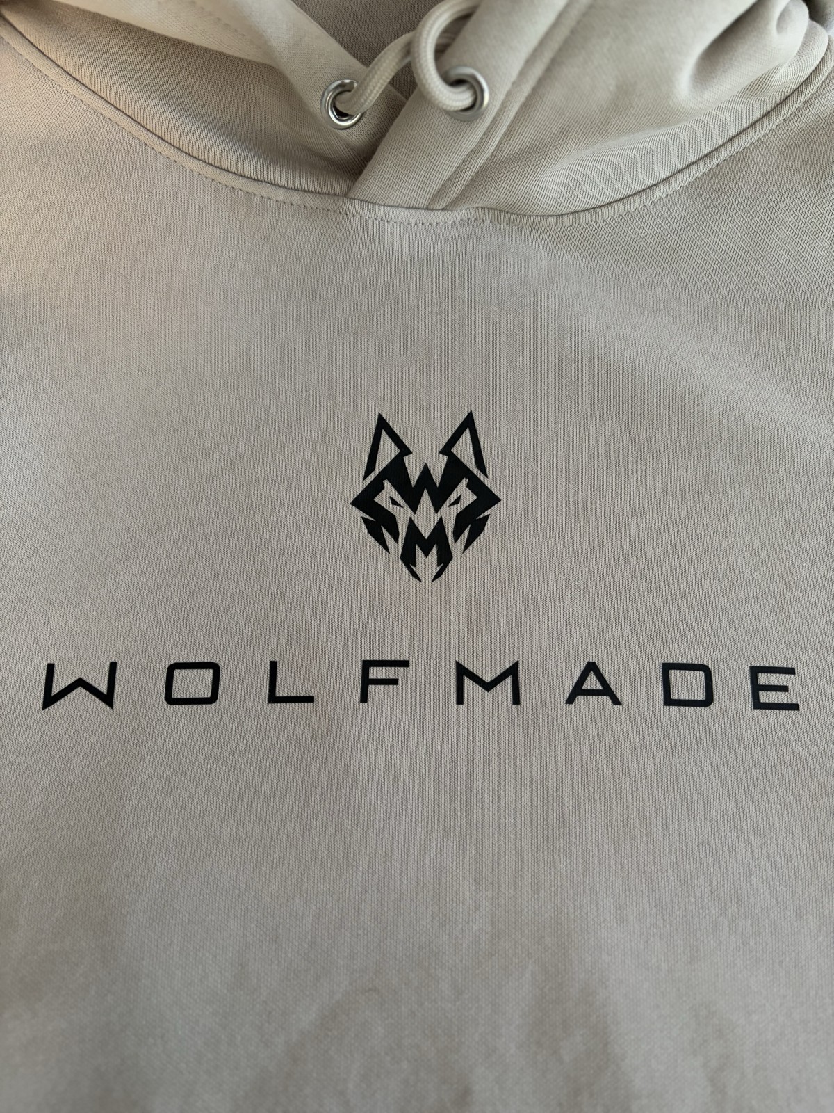Original photograph of the WOLFMADE chest branding and knit texture